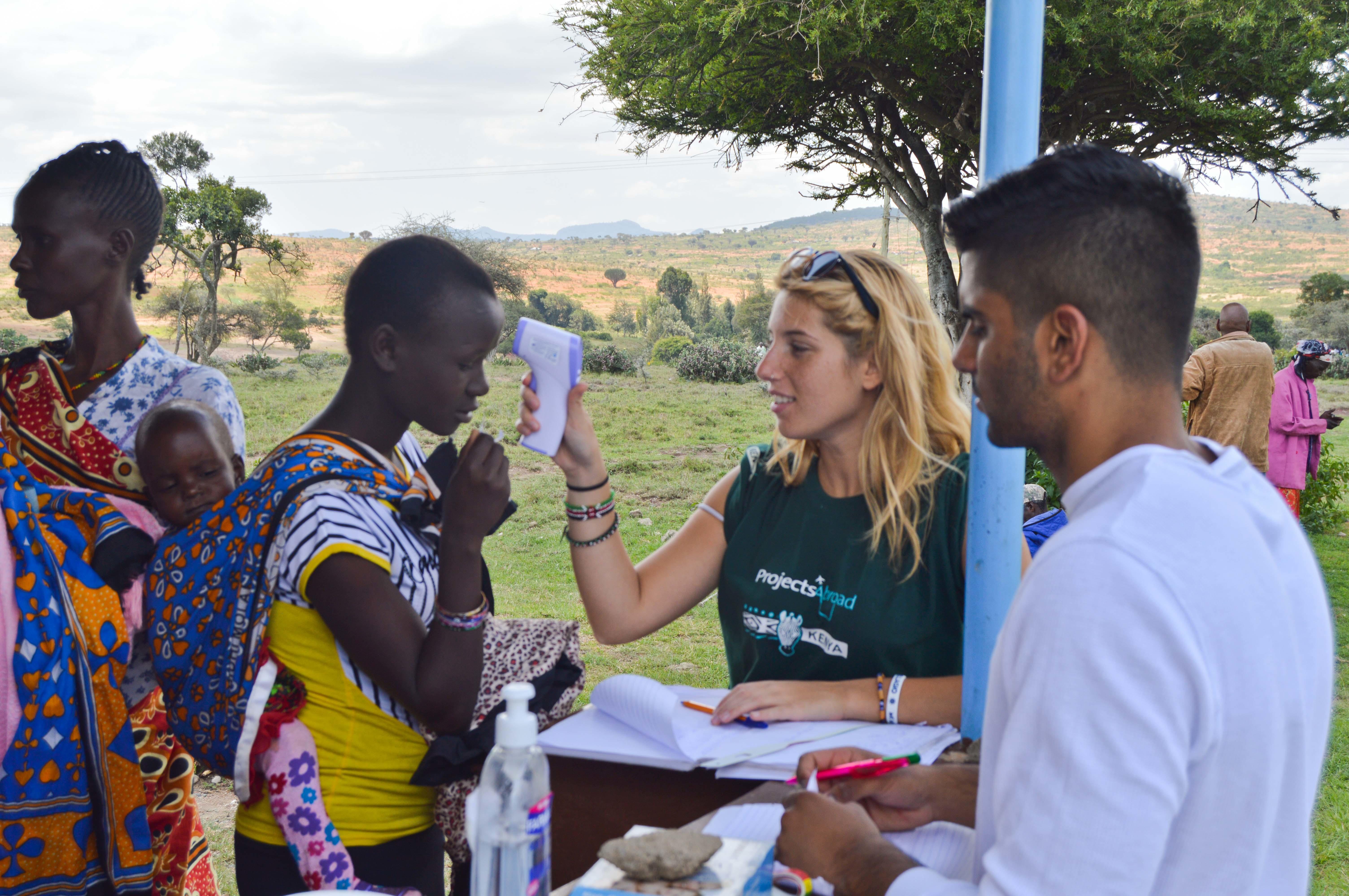 Projects Abroad work experience intern checking the temperature of local residents as part of her nursing internship in Kenya. A Projects Abroad intern pictured checking the temperature of local residents as part of her nursing internship in Kenya.